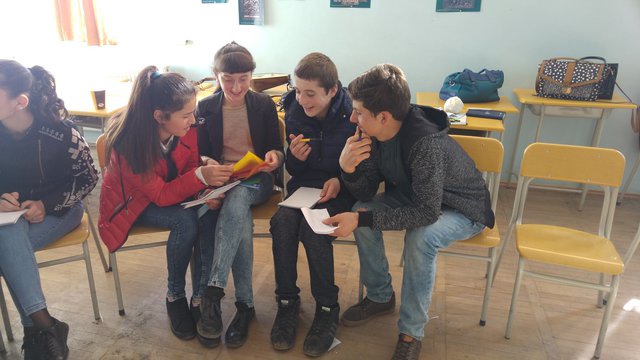 On  March 19th, first training for youth from Georgian and Avarian communities was held in Public school of Gavazi, Kvareli municipality.  First training was dedicated to the topic of "Intercultural dialogue", carried out by representatives of Cooperation for Peace and Progress, Salome Khvadagiani and Natia Chankvetadze. The main aim of the first meeting was to introduce participants to each other, overcome awkwardness in interaction and acquire some basic skills for team work and presentation. It should be noted, that at the beginning of the training, representatives of Tivi community (three boys and tree girls) were noticeably shy and tried to stay in their  group and avoid and participation. However, at the end of the day, they became visibly less uncomfortable or uneasy. Still, it is obvious, that representatives of Georgian community behave more like hosts of the event. 
Pictured on the photo: Two Avarians and two Georgian working on an assignment.